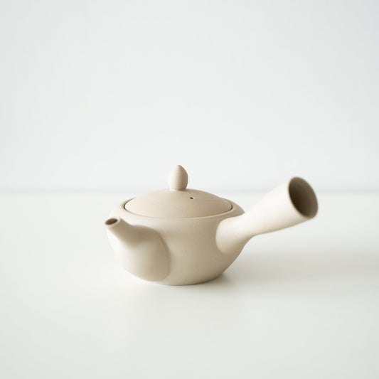 A Japanese white teapot on a white table