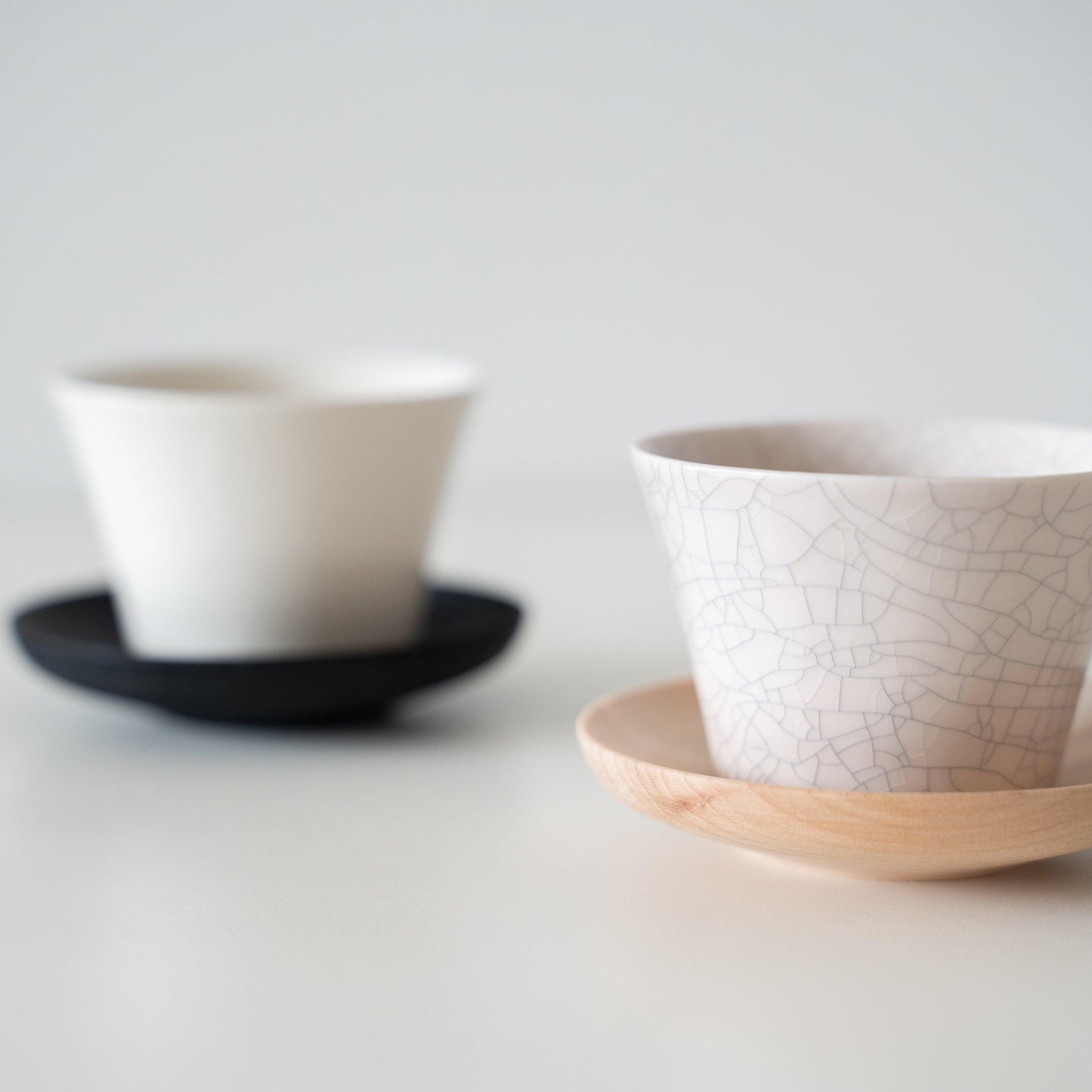 A delicate white Banko ware teacups with beautiful crackle glaze, embodying the concept of wabi-sabi.