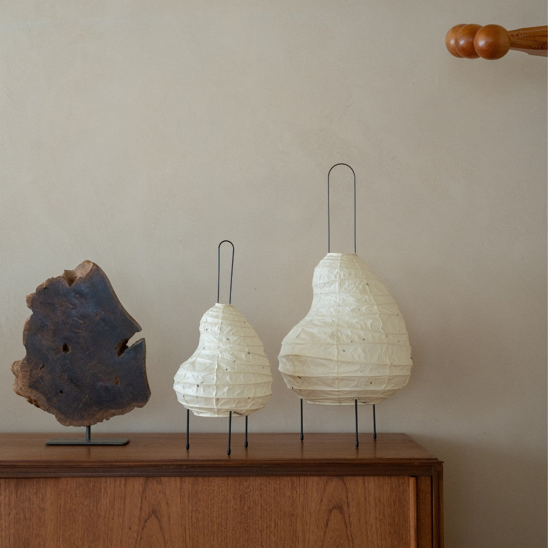 Two sizes of Japanese Washi Paper Floor Lamp “BEANS LIGHT” on a wood table in Japandi room - night paper lamp for Japanese bedroom