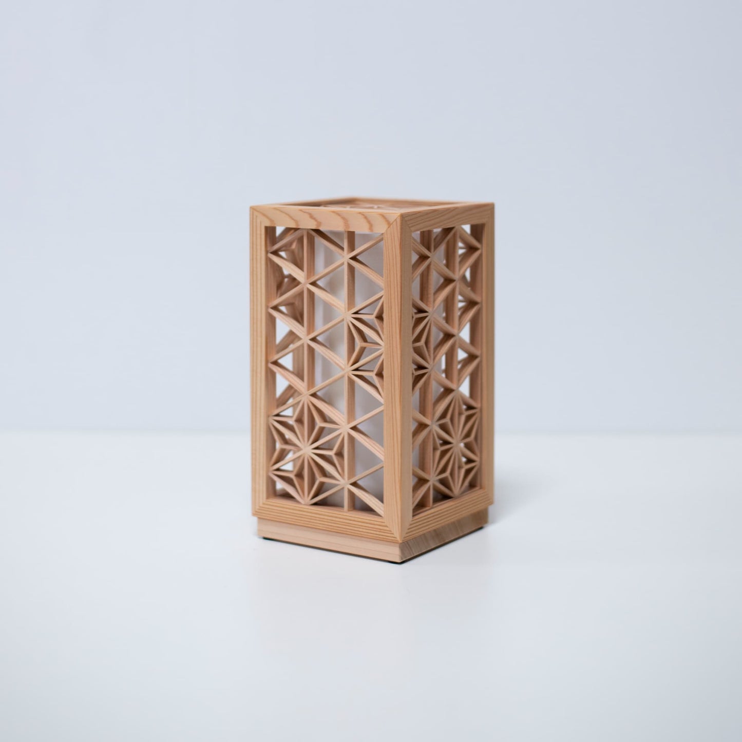 A table lamp using kumiko, a traditional Japanese technique of assembling small wooden pieces to create geometric patterns.