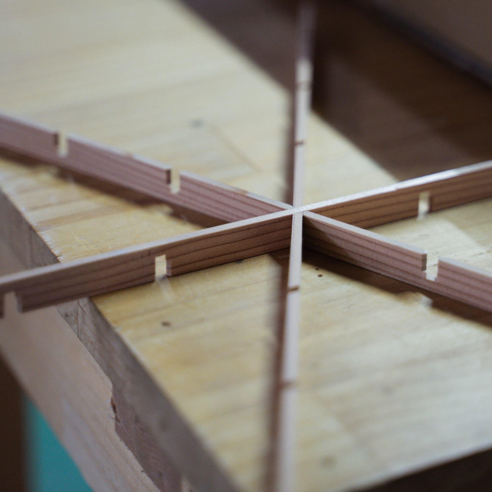 Pieces of Akita cedar, the material used for creating the delicate geometric patterns in kumiko craftsmanship, and individual kumiko components.