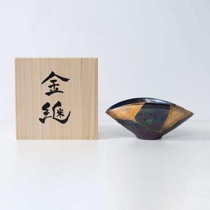 Handcrafted Kintsugi pottery bowl with gold repair, symbolizing wabi-sabi beauty