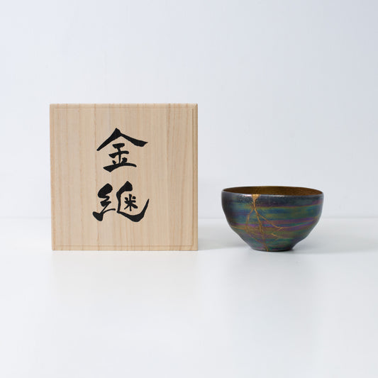 Kintsugi pottery bowl with gold repair, expressing Japanese wabi-sabi and resilience