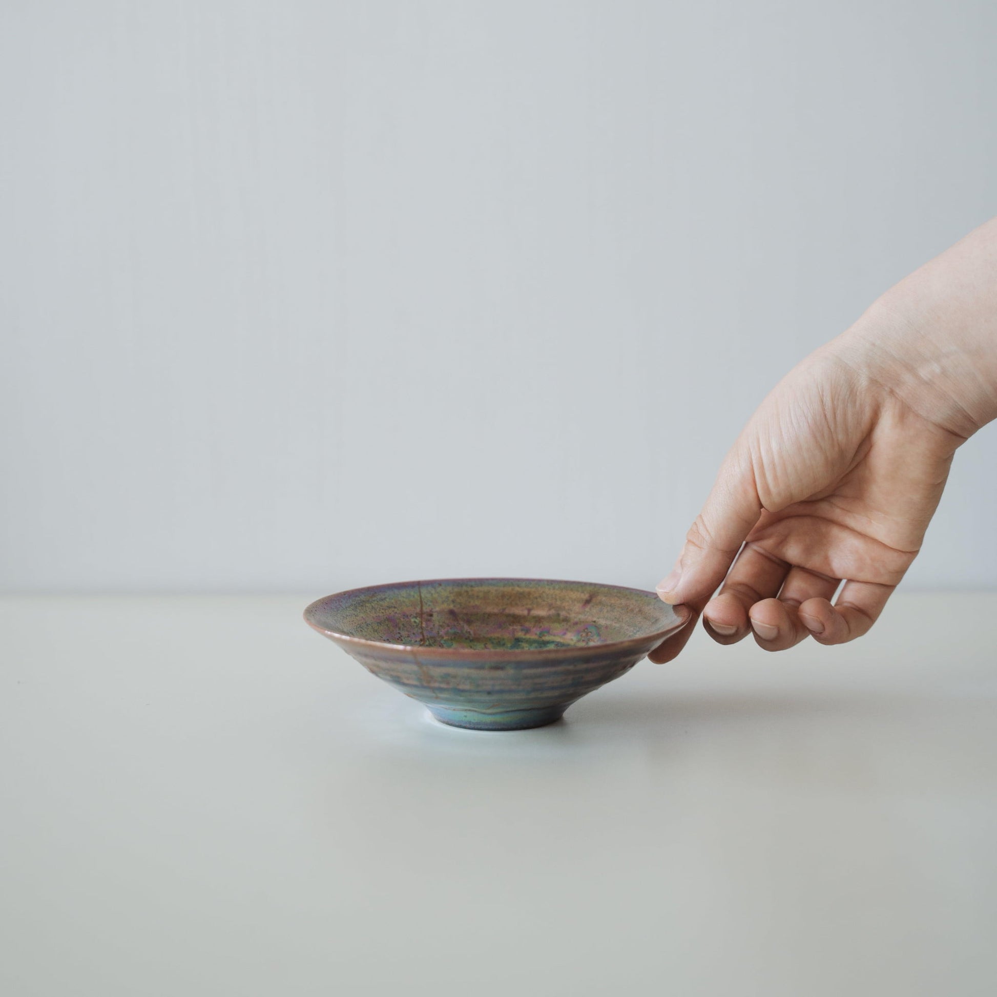 Hand holding Kintsugi Bowl "Supernova", showing its size and how it fits in the hand