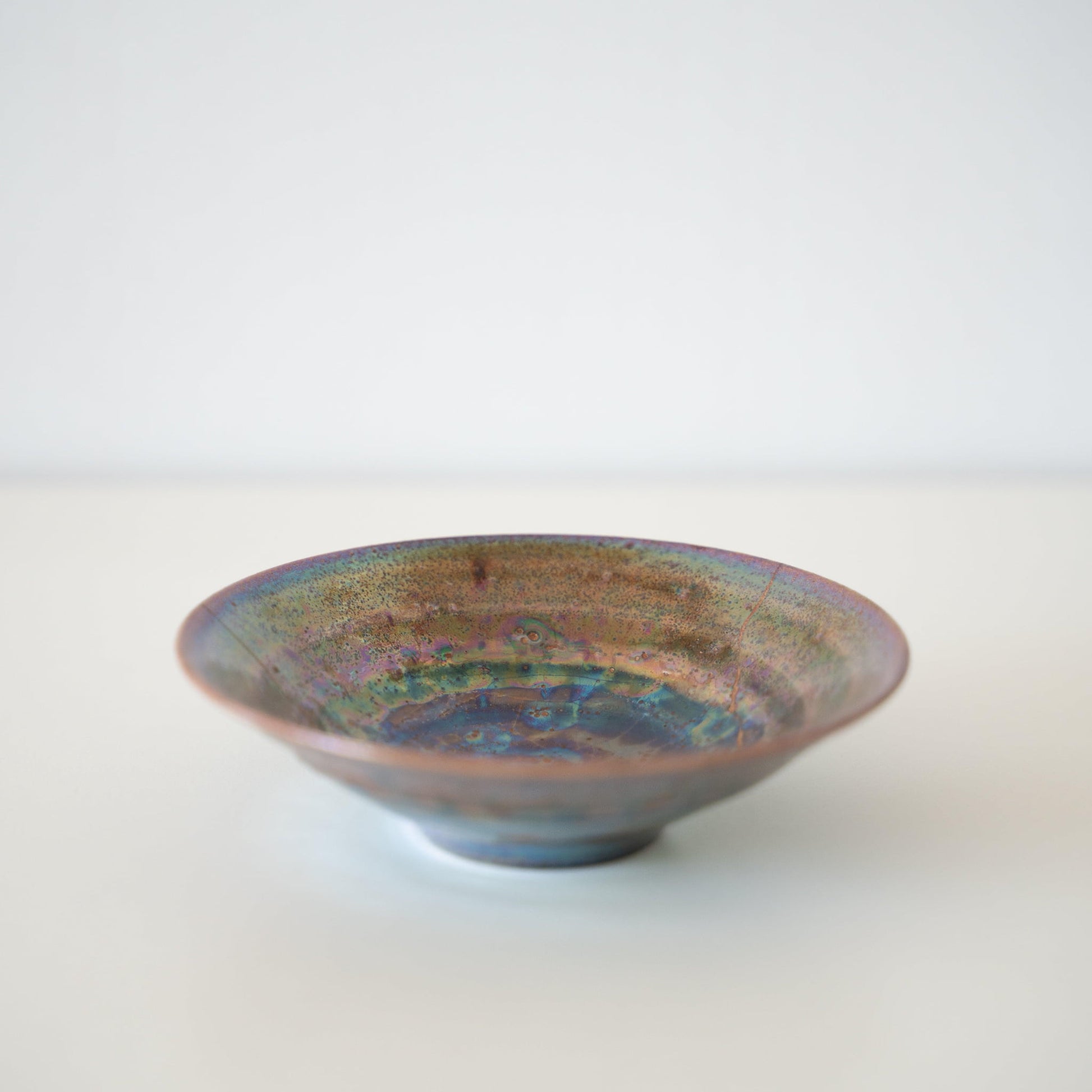 Side view of Kintsugi Bowl "Supernova" in a white background