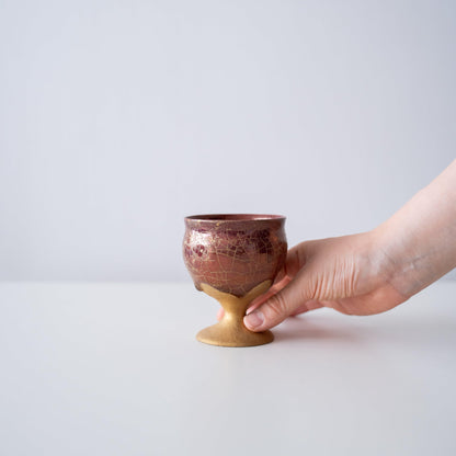 Hand holding Kintsugi Goblet "Gold Clay Crackle", showing its size and how it fits in the hand