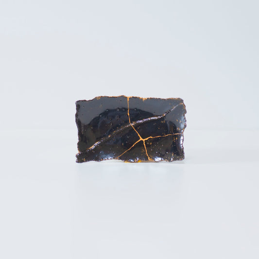 Side view of Kintsugi Plate "Tenmoku" Black 01 in a white background