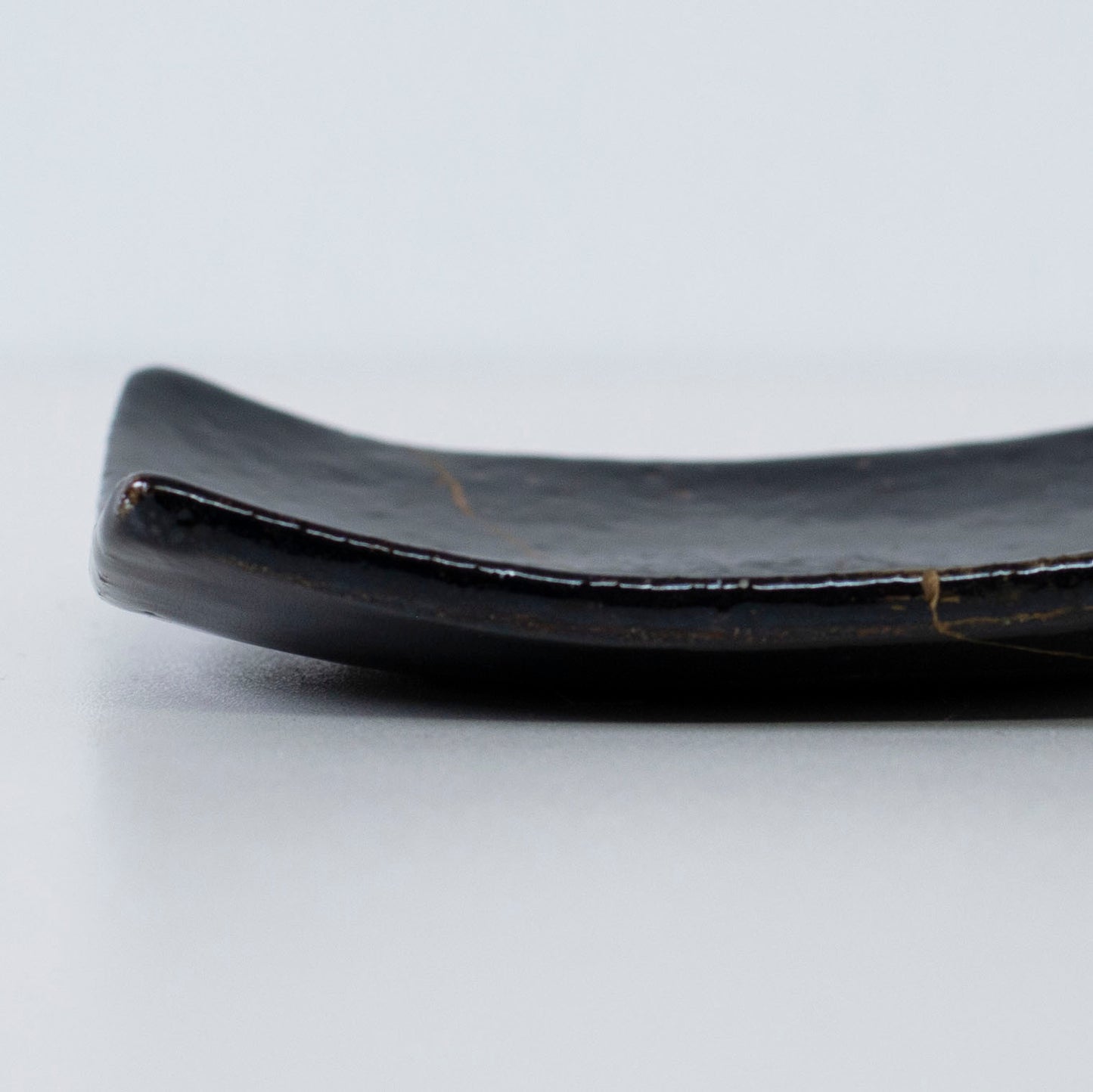 Close-up of the side profile of Kintsugi Square Plate "Jet Black Lighting" 05, highlighting the texture.
