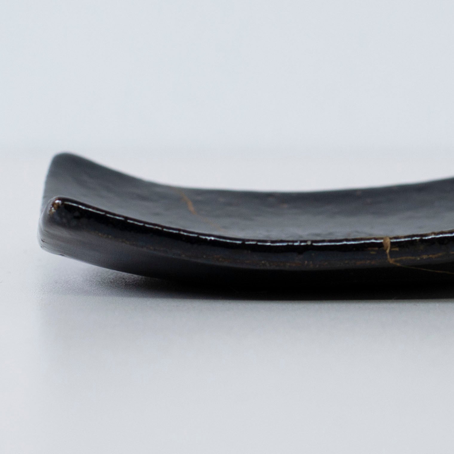 Close-up of the side profile of Kintsugi Square Plate "Jet Black Lighting" 05, highlighting the texture.