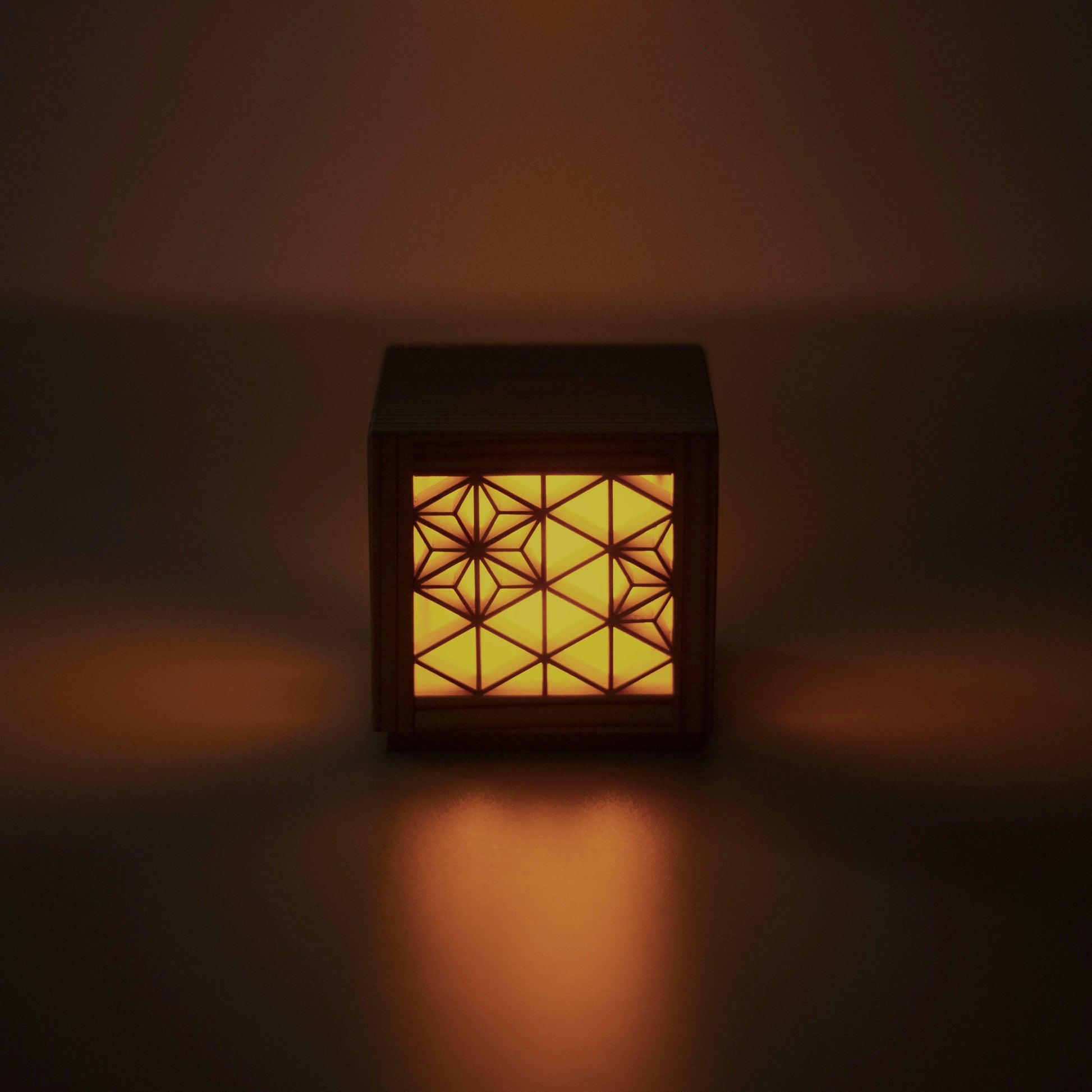 A front view of a kumiko lamp, highlighting the beautiful patterns created by the interlocking wooden pieces.