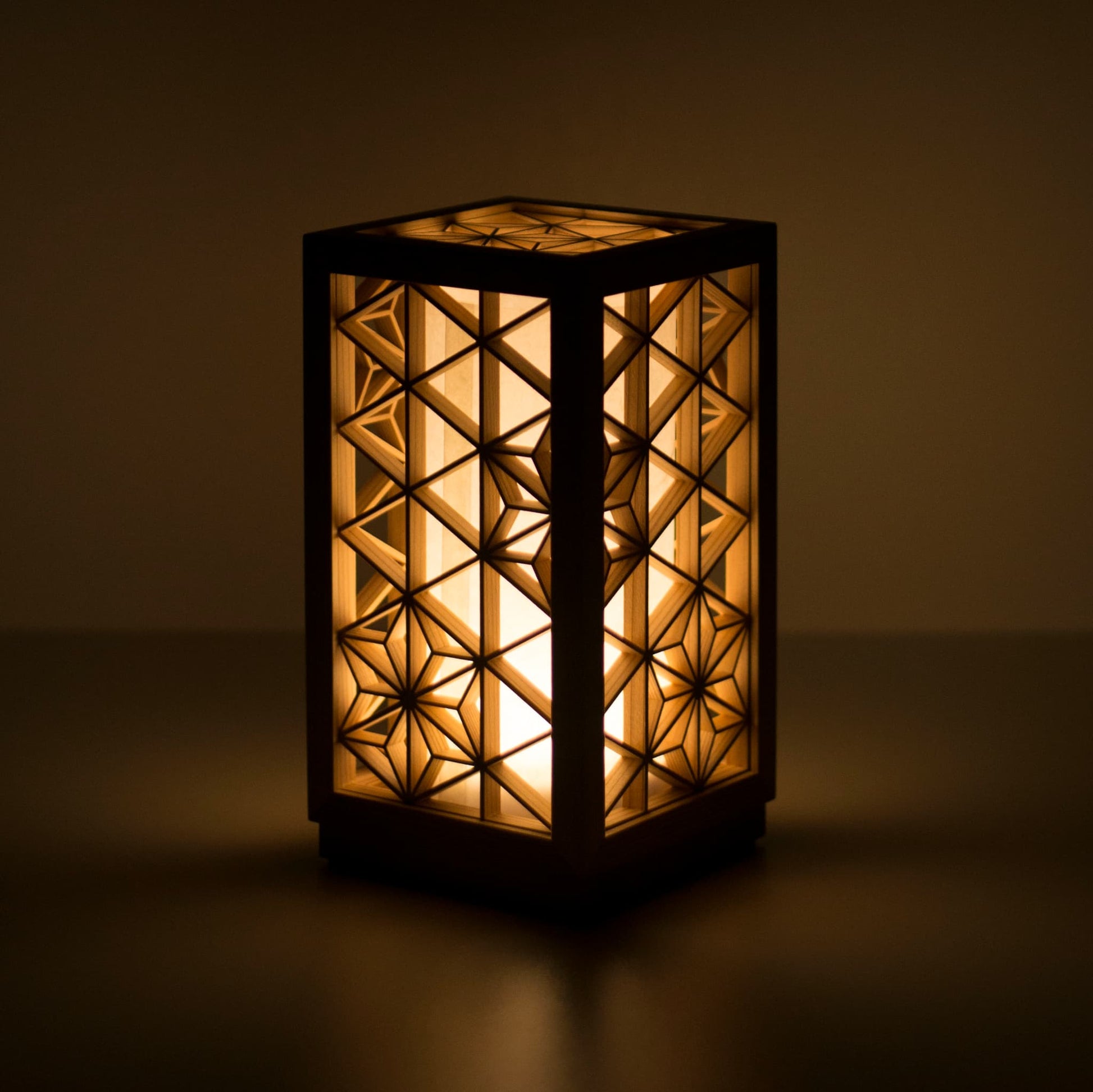 A table lamp using kumiko, a traditional Japanese technique of assembling small wooden pieces to create geometric patterns.