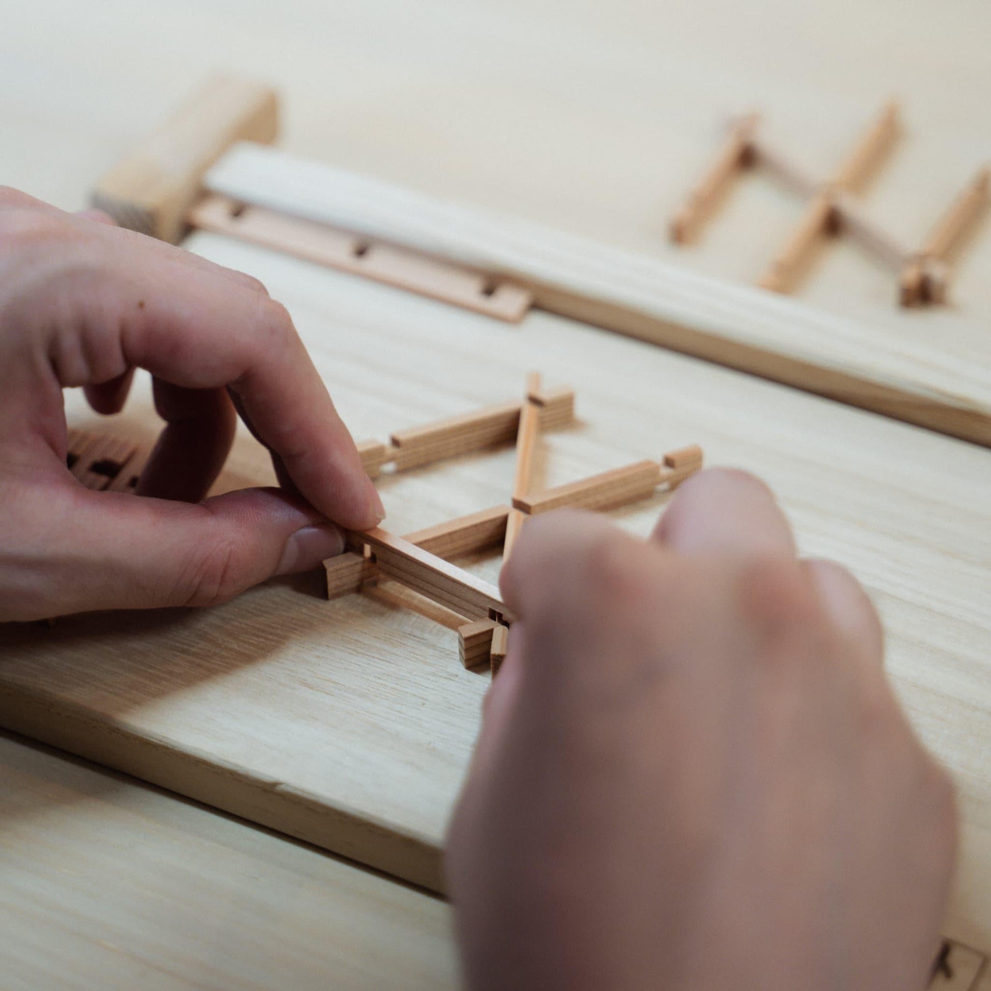 Pieces of Akita cedar, the material used for creating the delicate geometric patterns in kumiko craftsmanship, and individual kumiko components.