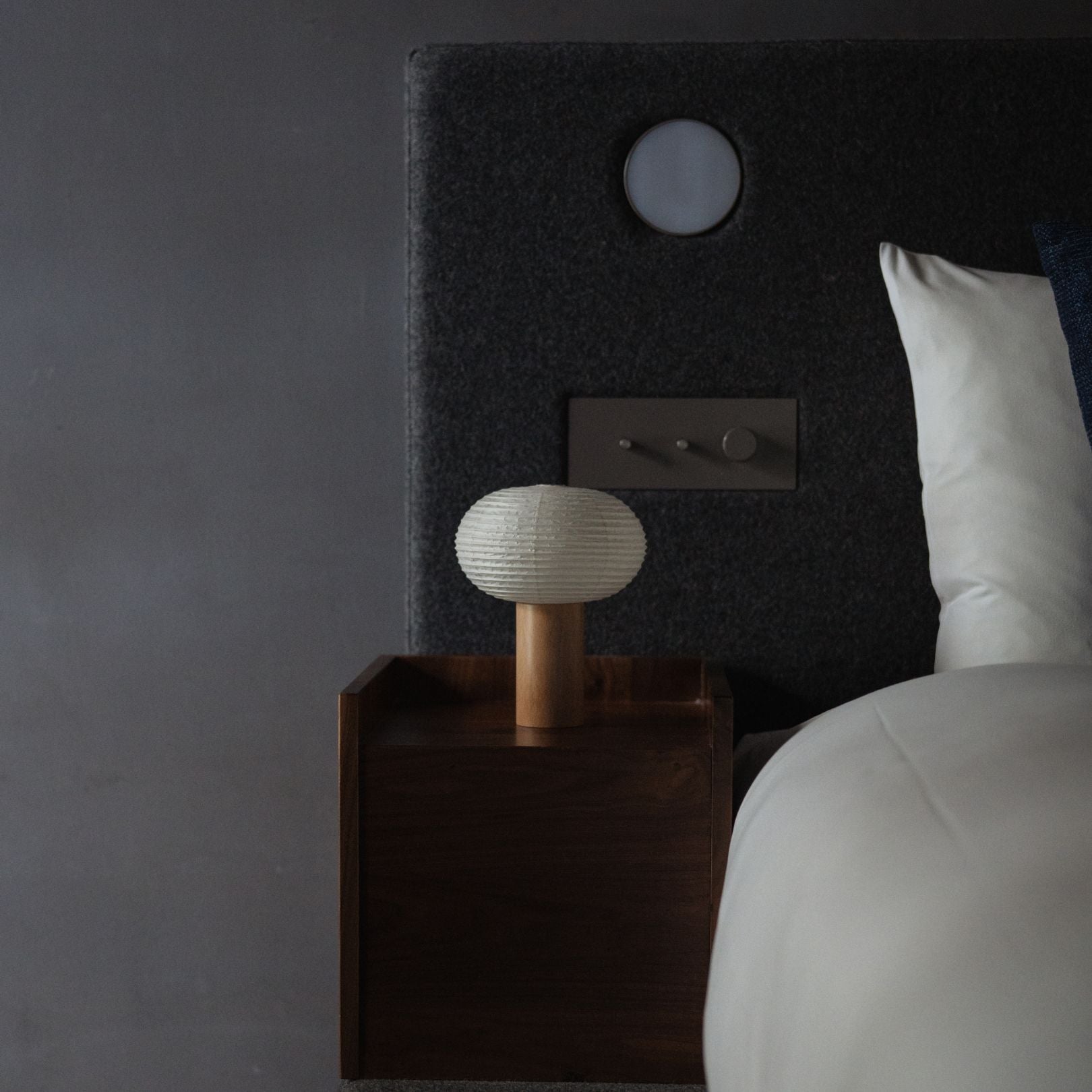 Japanese Paper Table Lamp "TORCHIN OVAL" on a bedside table in a Japandi bedroom