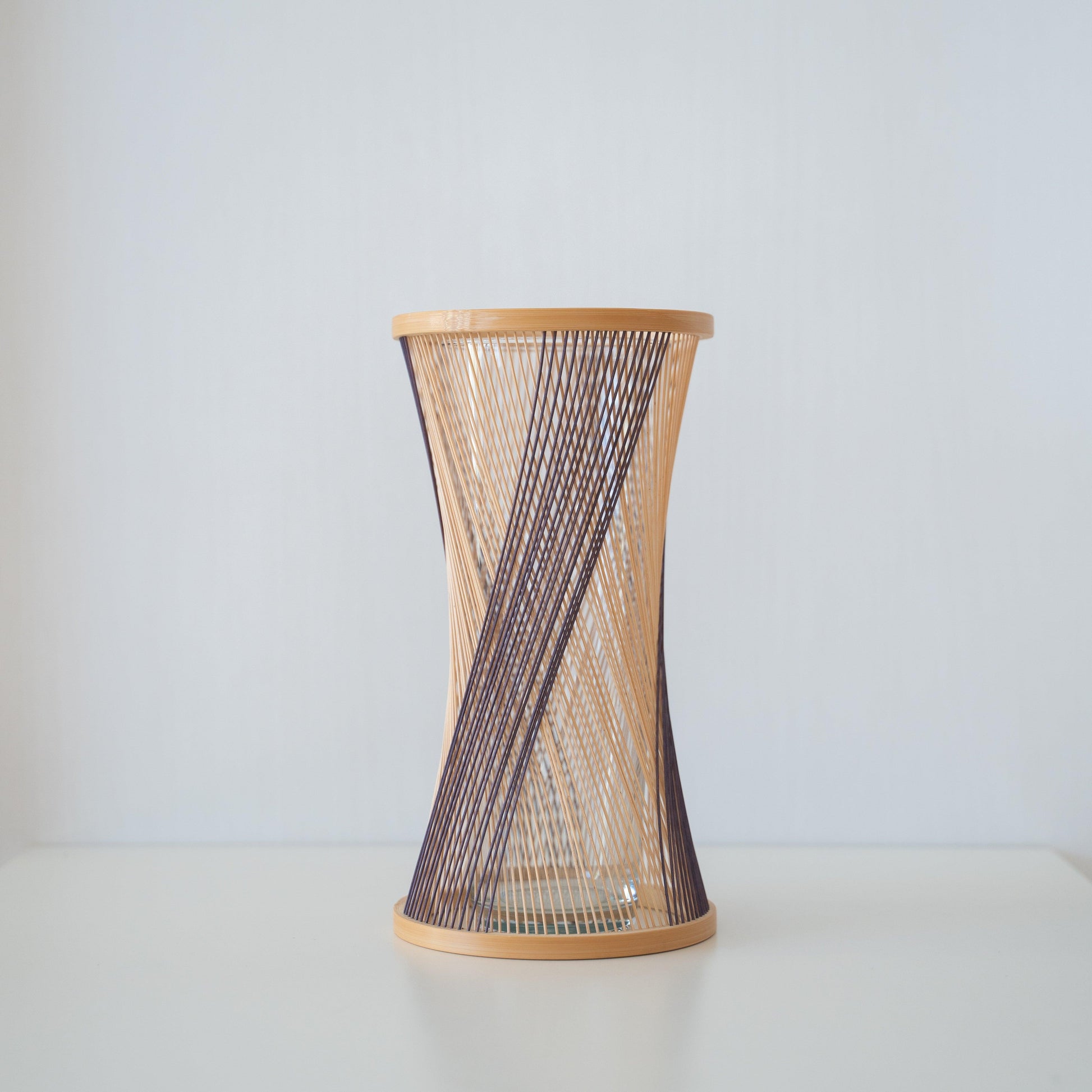 Handcrafted Japanese bamboo vase, meticulously crafted by skilled artisans using traditional bamboo weaving techniques, showcasing the natural beauty and elegance of bamboo.