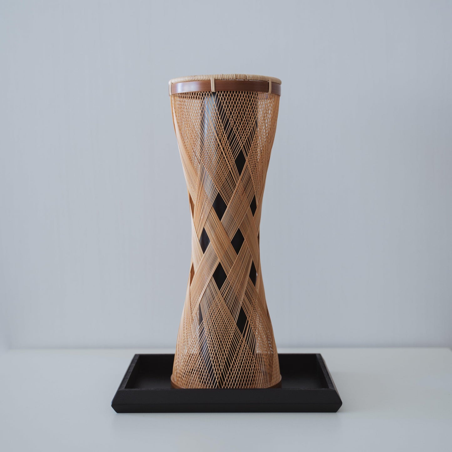 Handcrafted Japanese bamboo vase, meticulously crafted by skilled artisans using traditional bamboo weaving techniques, showcasing the natural beauty and elegance of bamboo.