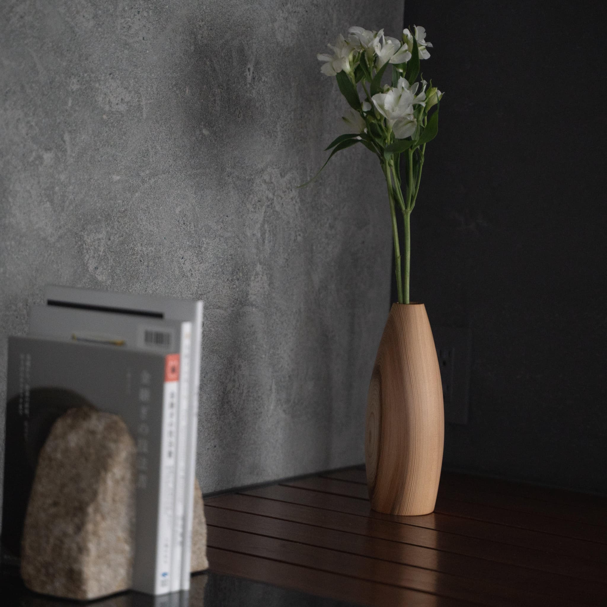 A simple cedar vase on a Japandi-style side table.