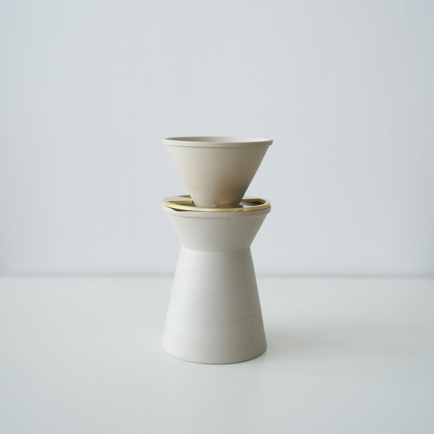 A minimalist white coffee server crafted with traditional Japanese Banko-yaki ceramic, featuring a smooth curve and matte finish.