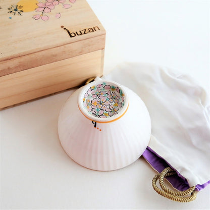 Handcrafted Japanese matcha bowl “Waraku” Flower by Buzan Kiln, with delicate cherry blossom motif inside and presented with a hand-painted wooden gift box.