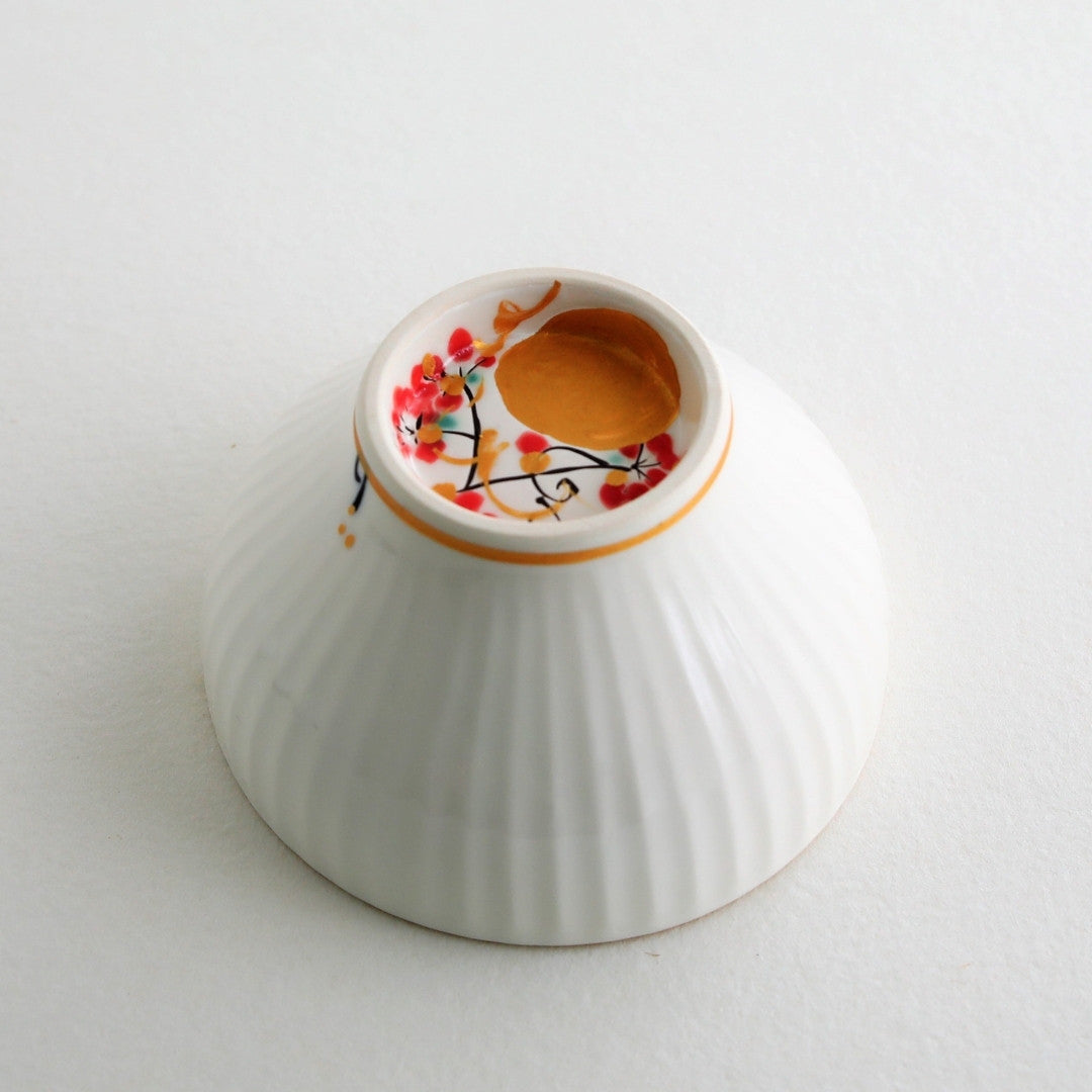 Close-up of Japanese matcha chawan bowl “Waraku” Moon, showing a hand-painted gold moon design on white porcelain with elegant sogi texture and gold rim.
