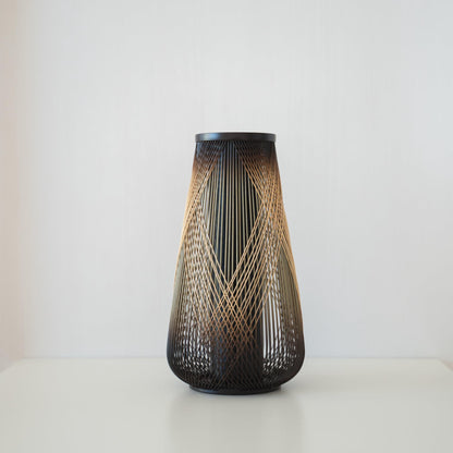 Handcrafted Japanese bamboo Ikebana vase, meticulously crafted by skilled artisans using traditional bamboo weaving techniques, showcasing the natural beauty and elegance of bamboo.