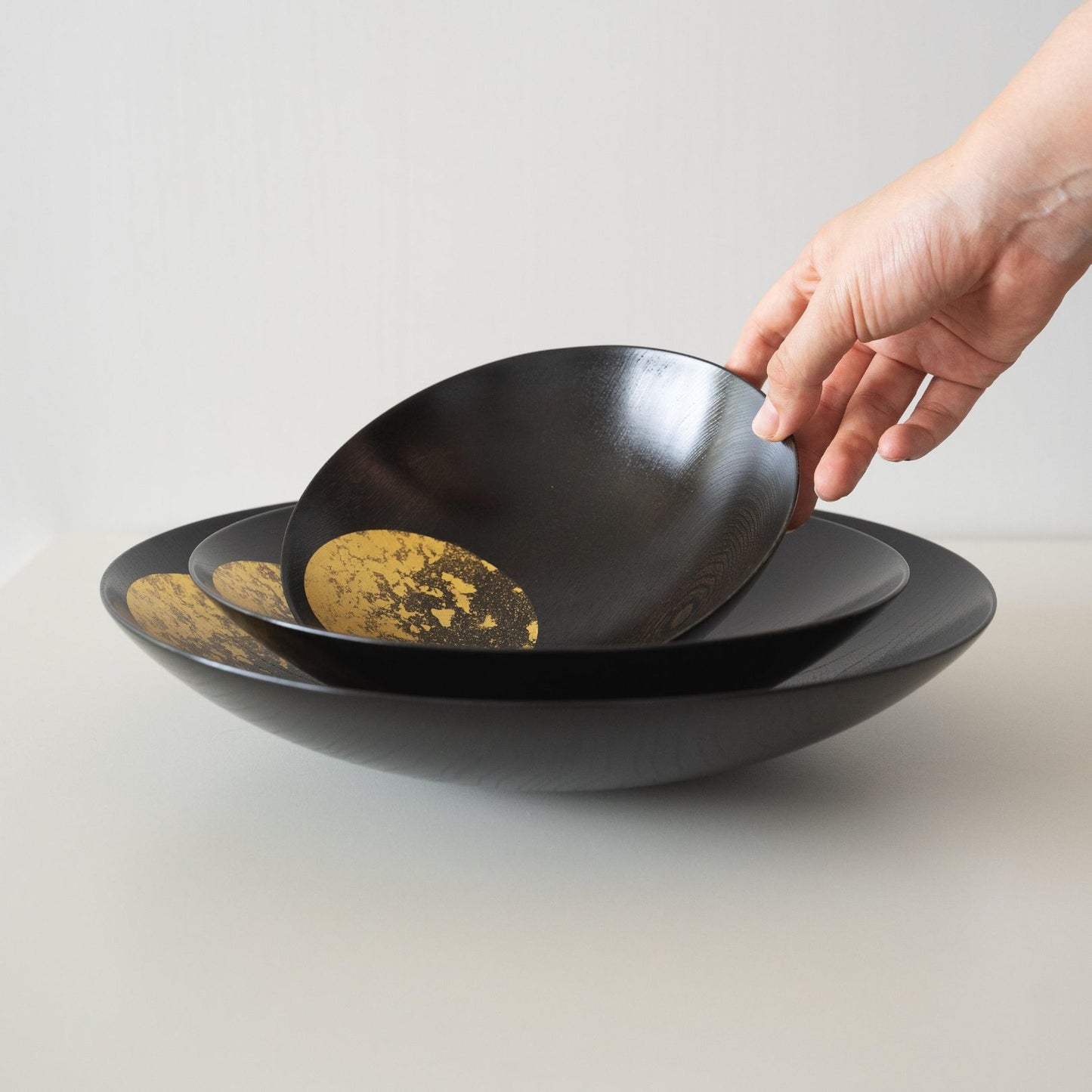 Hand Holding A Japanese Gold Leaf Lacquerware Bowl