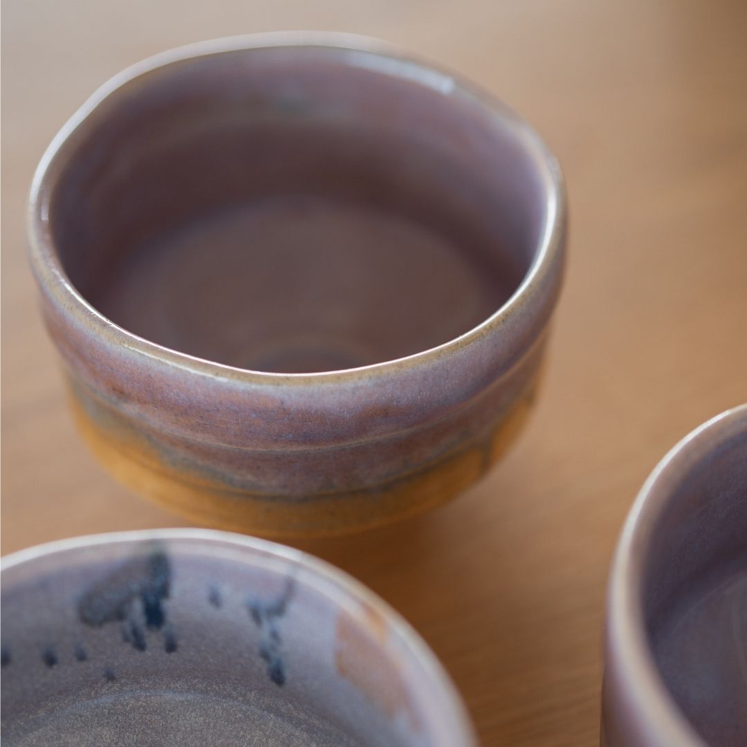 Close-up of a Pale Violet Haze Japanese matcha bowl from Shinzan Kiln, highlighting the glossy pale violet glaze blending with warm earthen brown tones, embodying the Wabi Sabi aesthetic.
