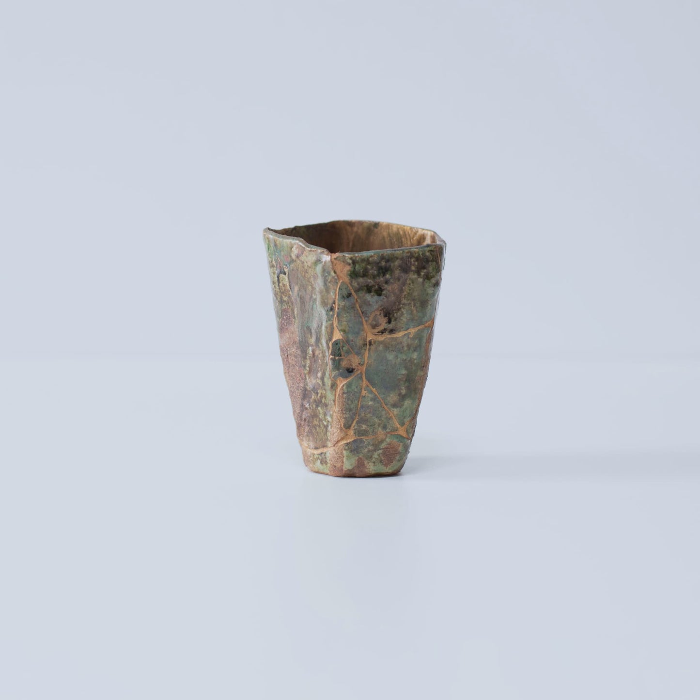 Side view of Pentagon Kintsugi Cup "Oribe" Deep Green 02 against white background