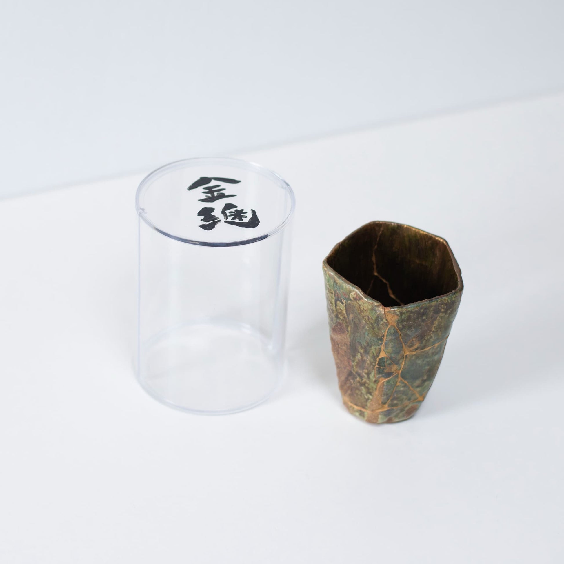 Pentagon Kintsugi Cup "Oribe" Deep Green 02 in clear presentation case, top view