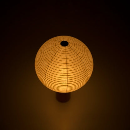 Portable light "TORCHIN CIRCLE" emitting a warm glow, handcrafted in Yame, Fukuoka, Japan, known for its traditional Yame lanterns.