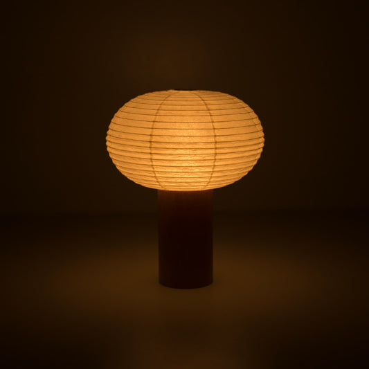 Portable light "TORCHIN OVAL" emitting a warm glow, handcrafted in Yame, Fukuoka, Japan, known for its traditional Yame lanterns.