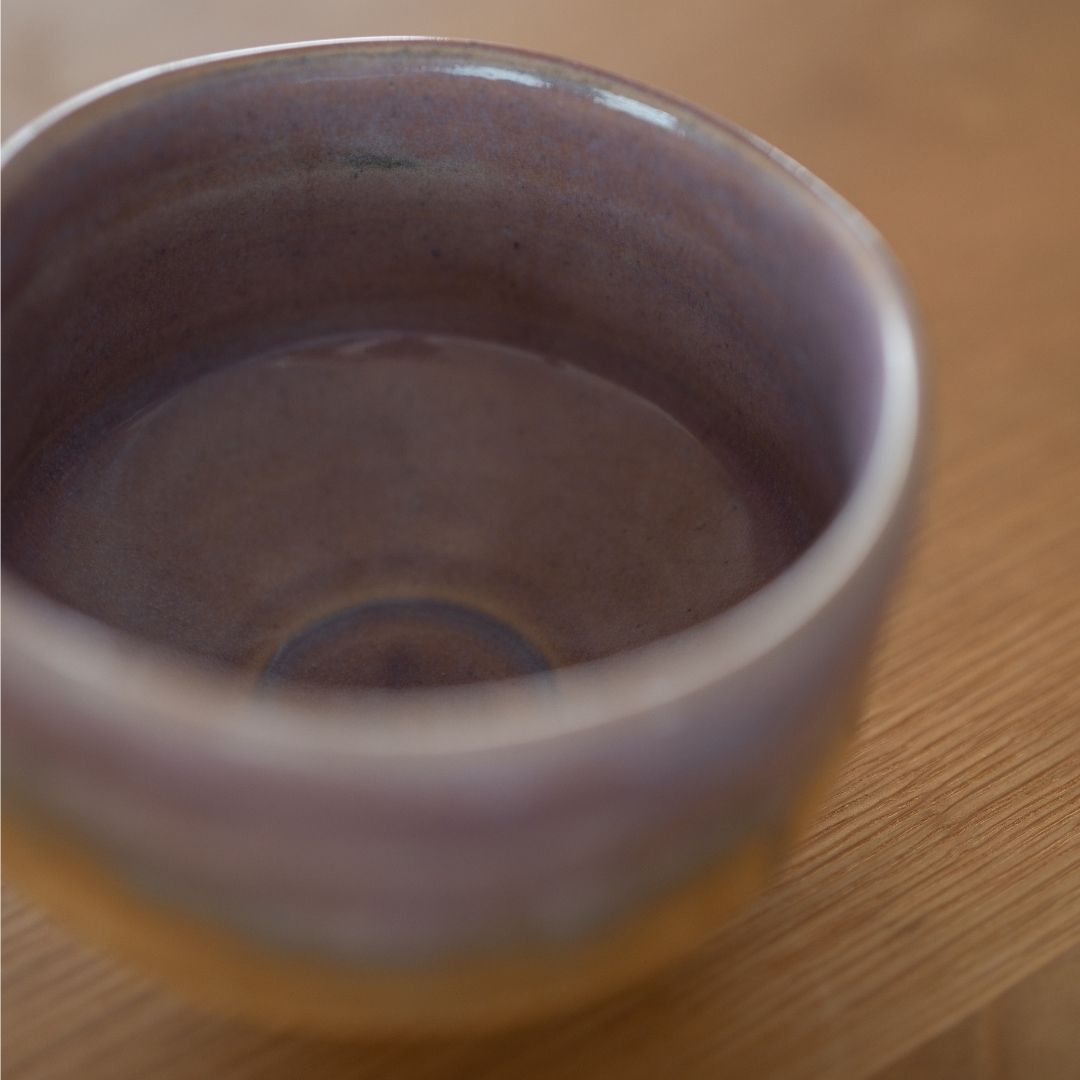 Close-up of the glossy, pale violet interior of the premium Mino Ware matcha bowl, handcrafted for a serene tea ceremony.