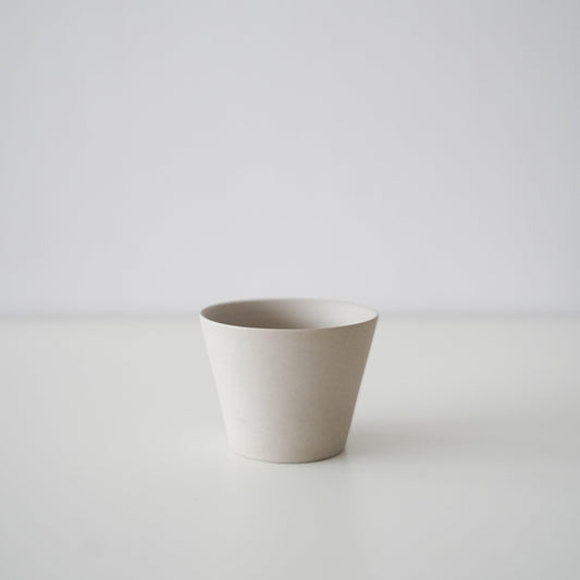 A minimalist white conical teacup from Banko ware.