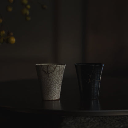 Two Kintsugi Cups on Black Table: "Vermilion Crackle 01" & "Jet Black Lightning"