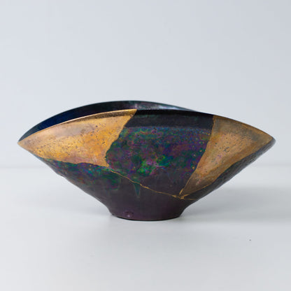 Side view of Kintsugi art bowl showing gold lacquer repairs and elegant wabi-sabi form