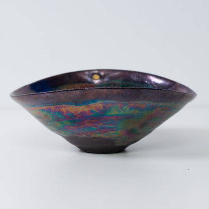 Japanese Kintsugi pottery bowl side view with metallic glaze and gold-filled cracks