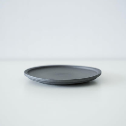 A simple black plate made of traditional Banko ware.