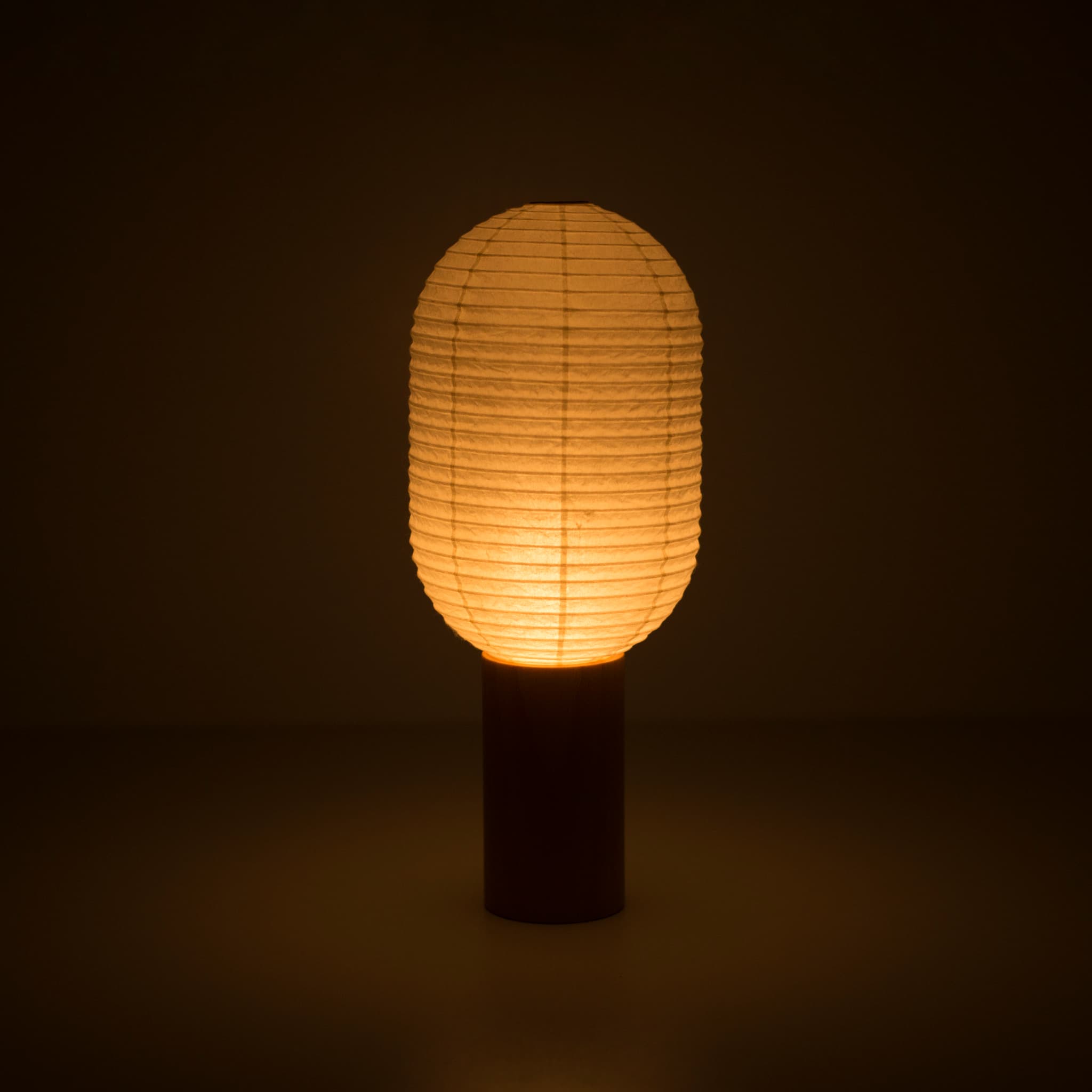 Portable light "TORCHIN VERTICAL" emitting a warm glow, handcrafted in Yame, Fukuoka, Japan, known for its traditional Yame lanterns.