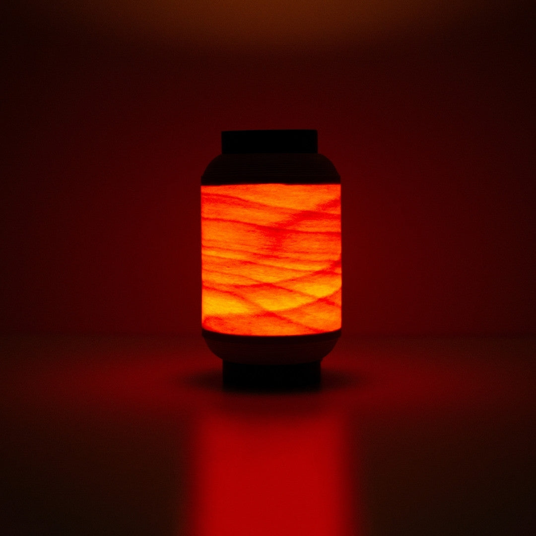 Japanese wood light lamp casting warm reddish glow, inspired by traditional festival lanterns.