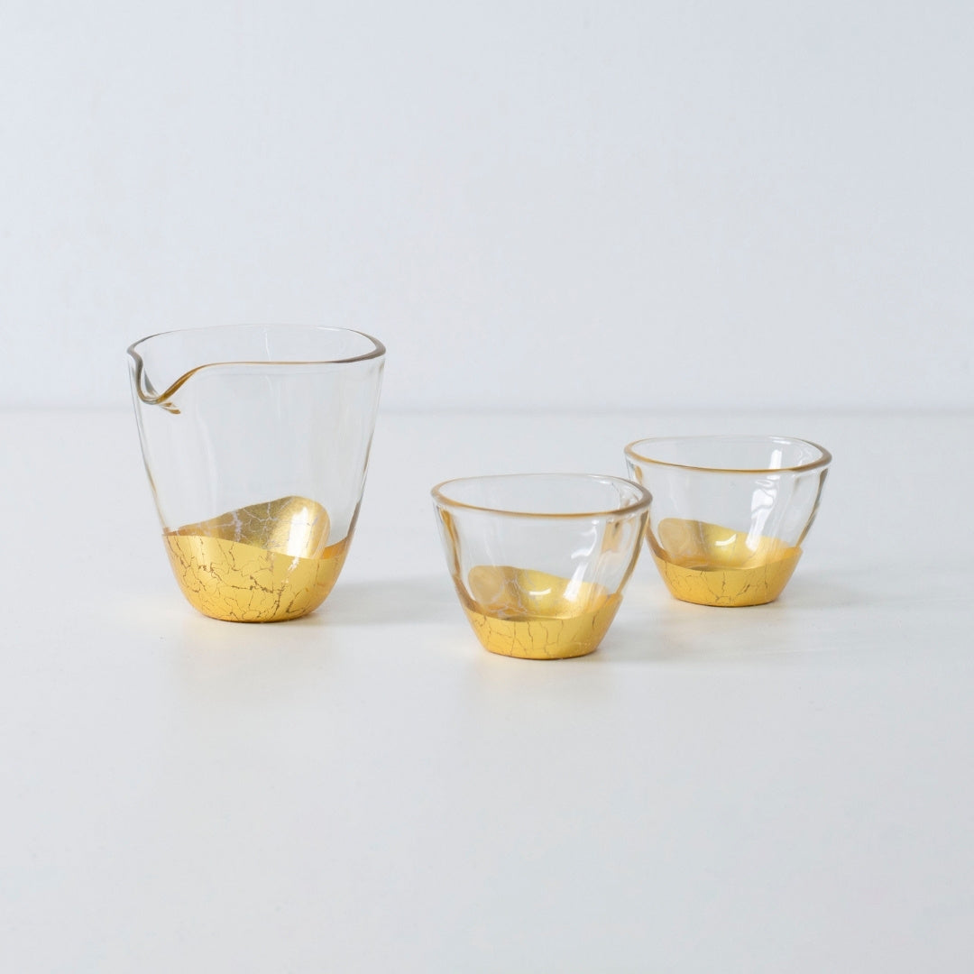 Elegant Japanese sake set with gold leaf design, including sake bottle and two cups in crackled finish