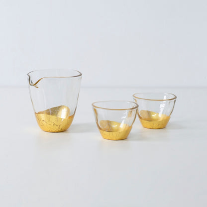 Elegant Japanese sake set with gold leaf design, including sake bottle and two cups in crackled finish