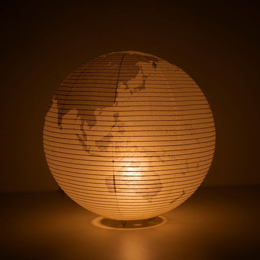 The Japanese Paper Floor Lamp "paper moon 05G" glowing softly, globe-inspired floor lamp