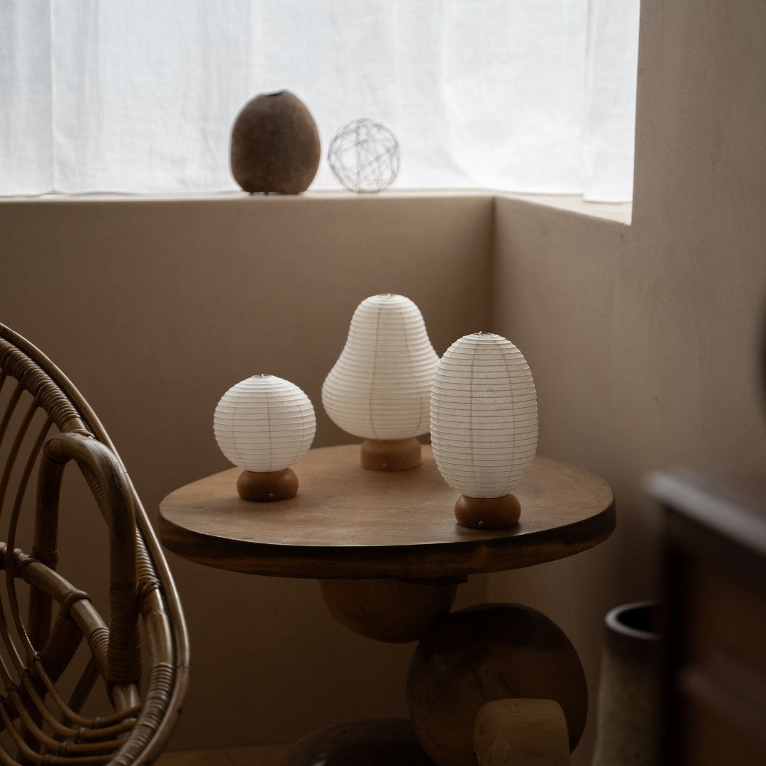 Three Japanese Paper Table Lamps on wooden table in Japandi style room – Unique portable lamps for bedside tables