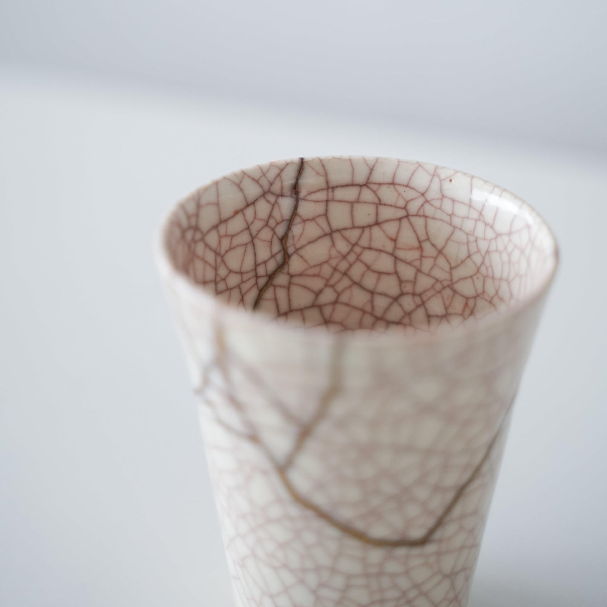 Top view of Kintsugi Cup "Vermilion Crackle" 02, showcasing its unique pentagonal shape