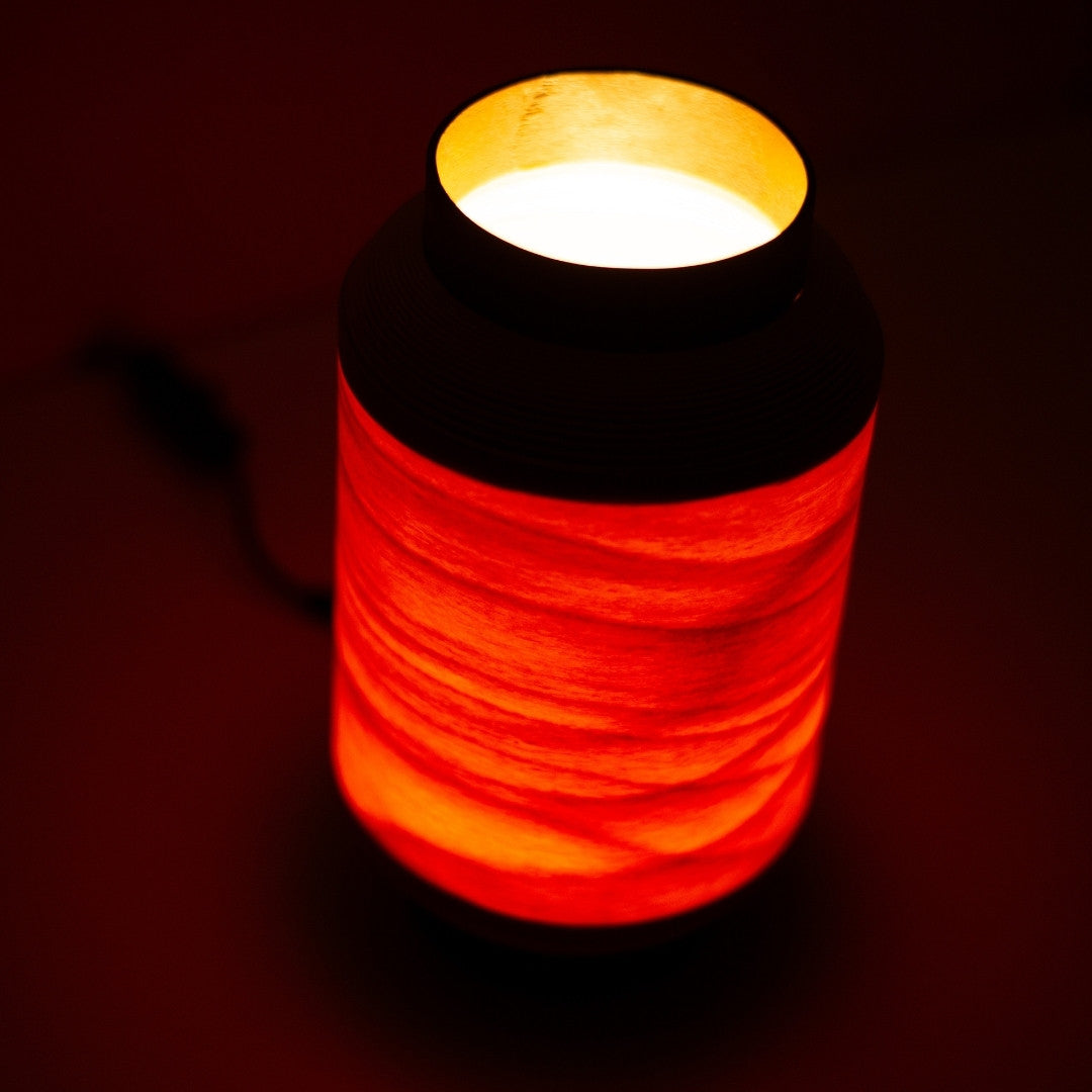 Top view of BUNACO-crafted Japanese table lamp with ambient light filtering through wood shade.