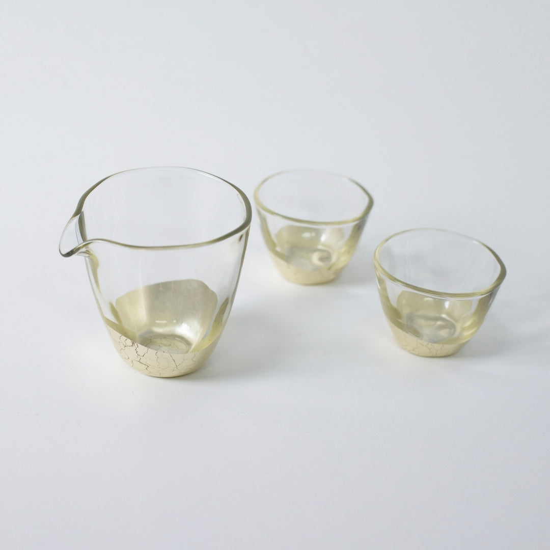 Top view of champagne gold Japanese sake set with Kanazawa leaf, bottle and cups by HAKUICHI