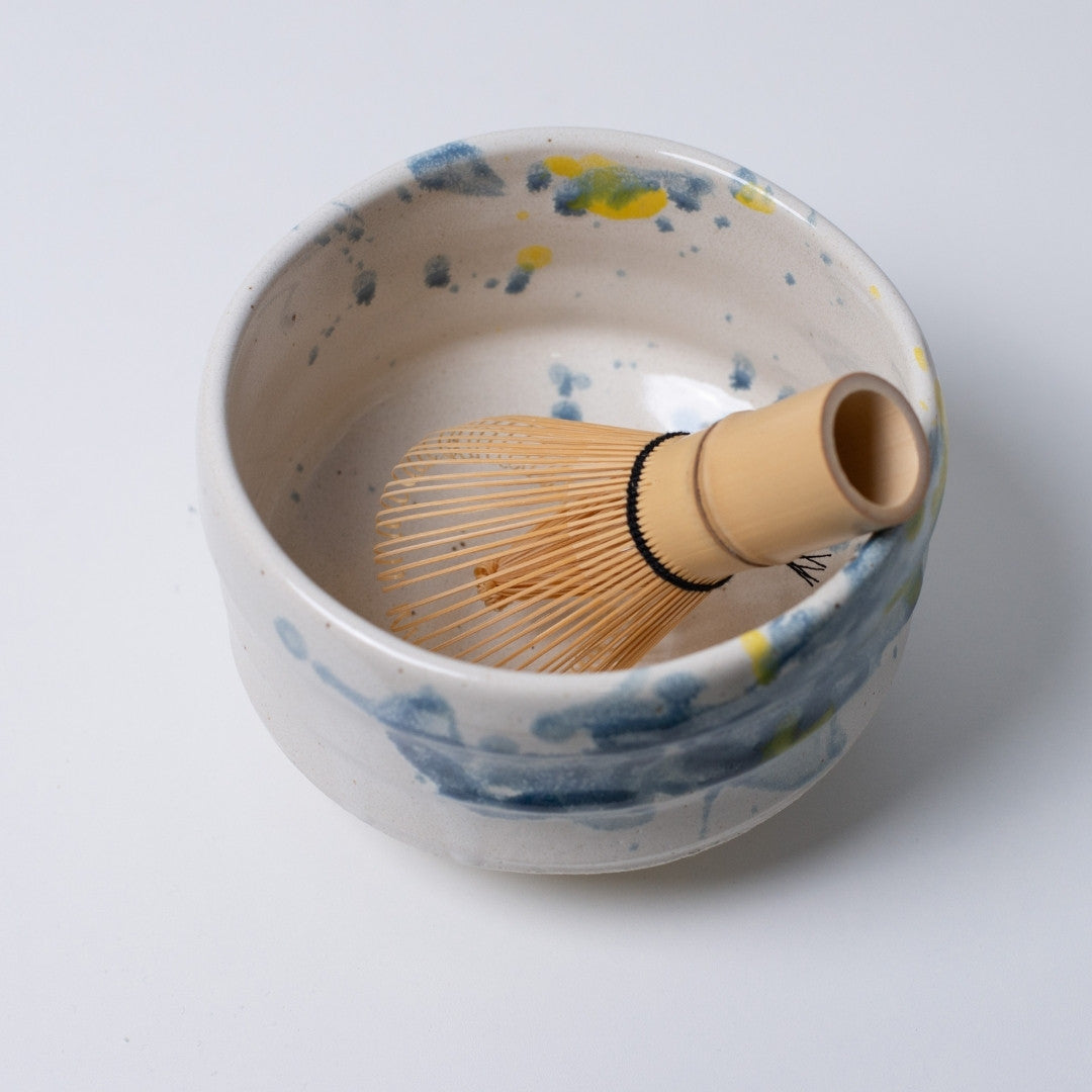 Top view of Japanese matcha bowl "Splash" with refreshing blue-yellow glaze for summer tea.