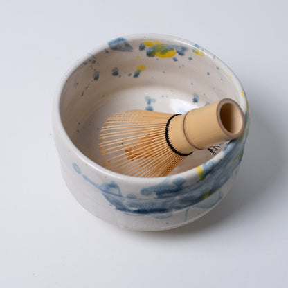 Top view of Japanese matcha bowl "Splash" with refreshing blue-yellow glaze for summer tea.
