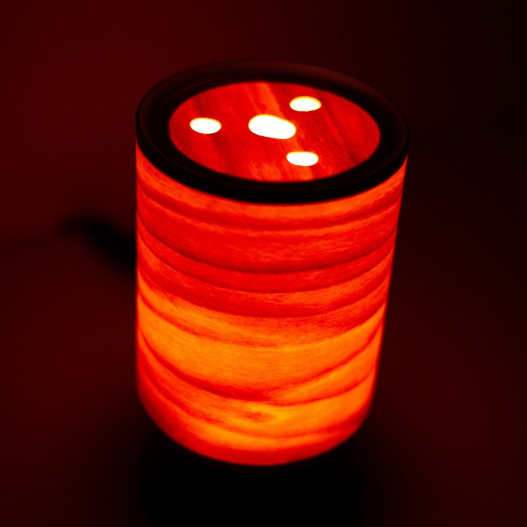 Top view of elegant Japanese wood light lamp glowing softly, crafted with BUNACO technique.