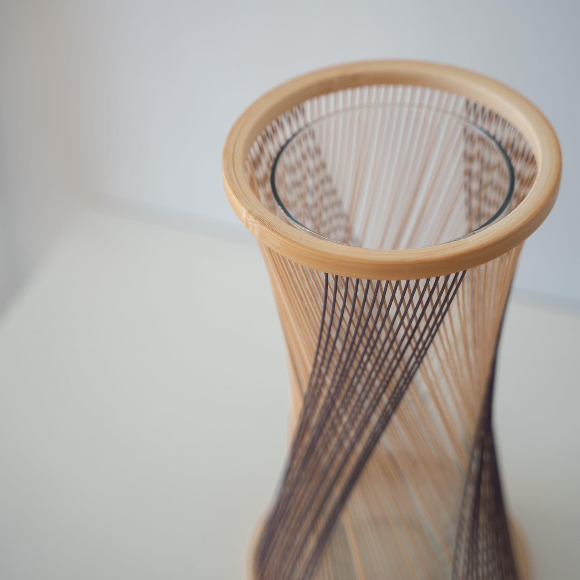 Handcrafted Japanese bamboo vase, meticulously crafted by skilled artisans using traditional bamboo weaving techniques, showcasing the natural beauty and elegance of bamboo.