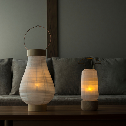 Two traditional Japanese paper lanterns dimly lit in a Japanese-style room